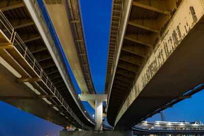 Low angle view of elevated road against blue sky