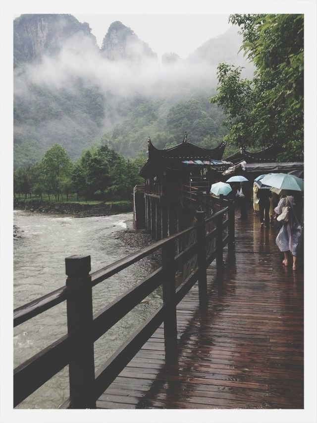 mountain, tree, water, transfer print, built structure, sky, men, railing, lifestyles, architecture, lake, auto post production filter, leisure activity, person, river, scenics, tourist, nature, place of worship