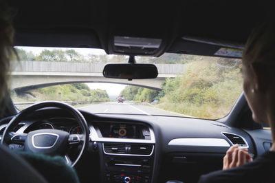 Rear view of man driving car