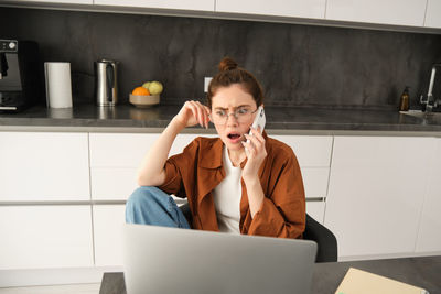 Young woman using laptop at home