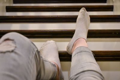 Low section of woman laying on steps