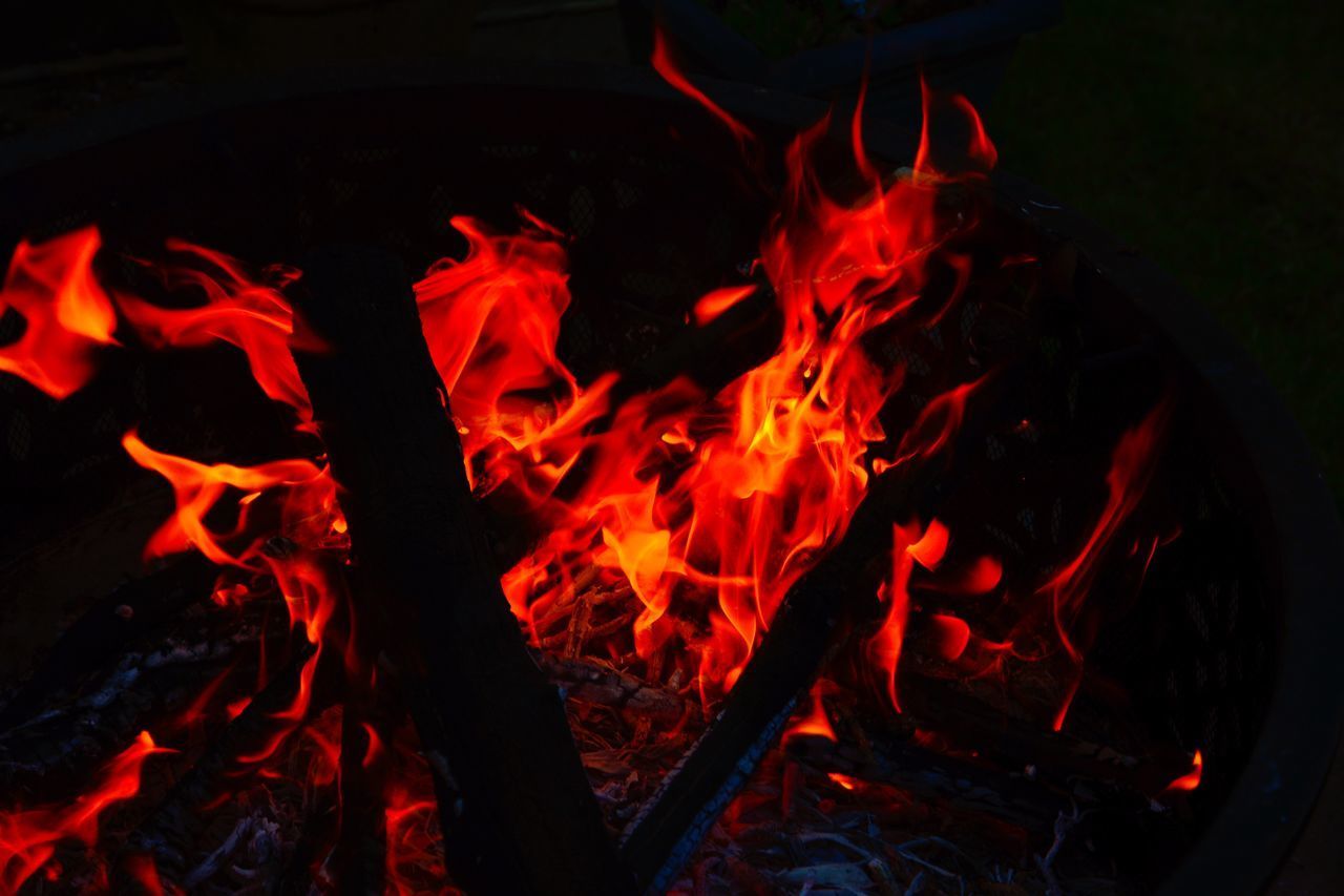 HIGH ANGLE VIEW OF BURNING FIRE IN THE DARK