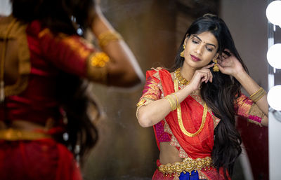 Midsection of woman holding umbrella