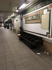 Woman sitting on railroad station platform