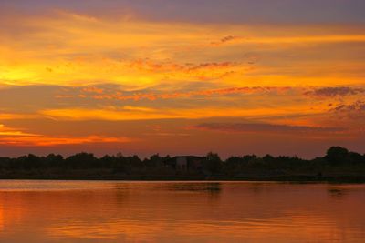 Scenic view of lake against romantic sky at sunset