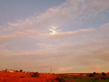 Scenic view of field against sky during sunset