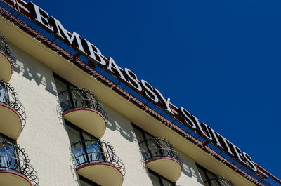 Low angle view of building against clear blue sky