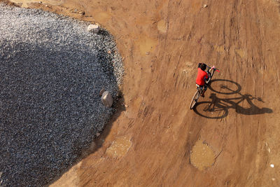 High angle view of man riding bicycle on street