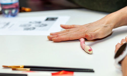 Cropped hand of man working on table