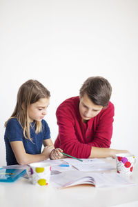 Brother helping sister with homework