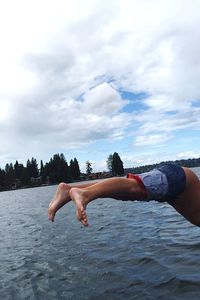 Low section of man diving into lake