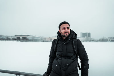 Portrait of young man standing in winter