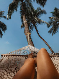 Low section of woman relaxing on hammock