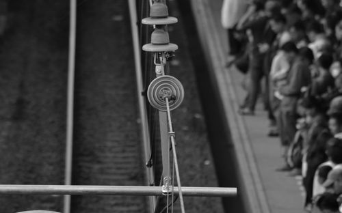 High angle view of insulator on power line over railroad tracks