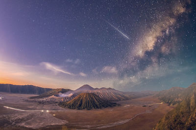 Scenic view of mountains against sky at night