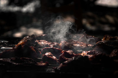 Steam emitting from meat on barbecue grill