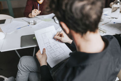 High angle view of businessman planning strategy during meeting at office