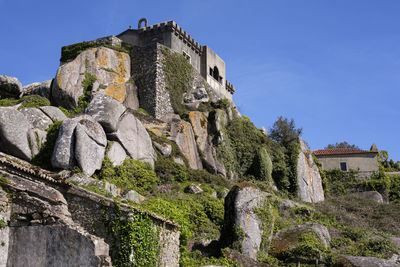 Low angle view of old ruins against clear blue sky