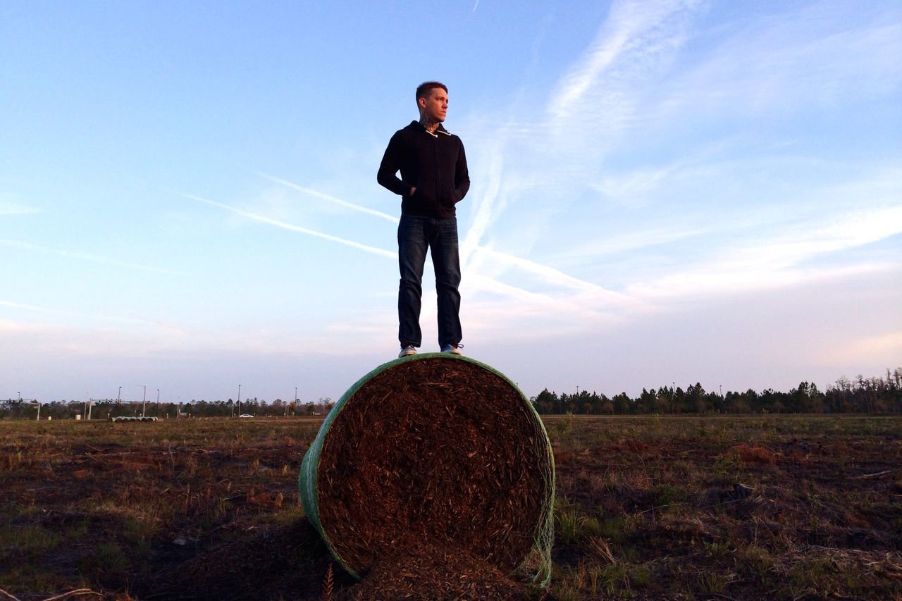 lifestyles, standing, casual clothing, leisure activity, full length, sky, young adult, field, young men, sunglasses, person, landscape, front view, grass, portrait, cloud, nature, three quarter length