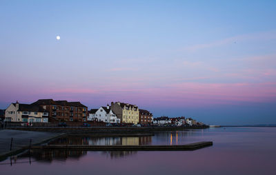 Reflection of houses in sea at night