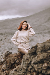 Woman on rock at beach