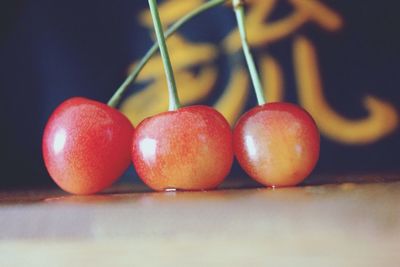 Close-up of cherries on table