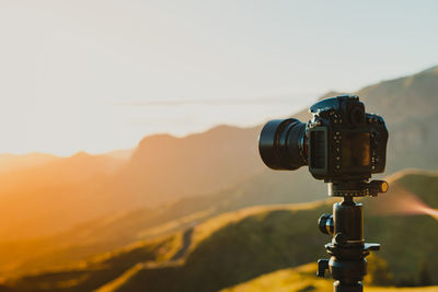 Close-up of camera against sky