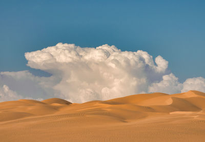Imperial sand dunes near yuma, arizona. aerial with blue sky and puffy white clouds.