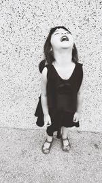 Close-up of girl standing against wall