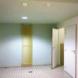 Open door of illuminated public toilet