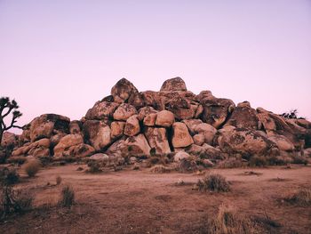 Rock formations on landscape against clear sky