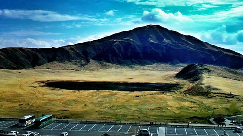 Scenic view of mountains against cloudy sky