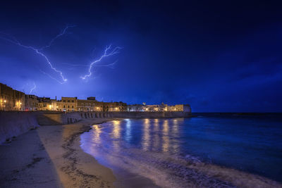 Lightning in sky over city at night