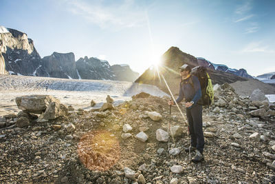 Backpacker standing on glacial moraine in auyuittuq national park