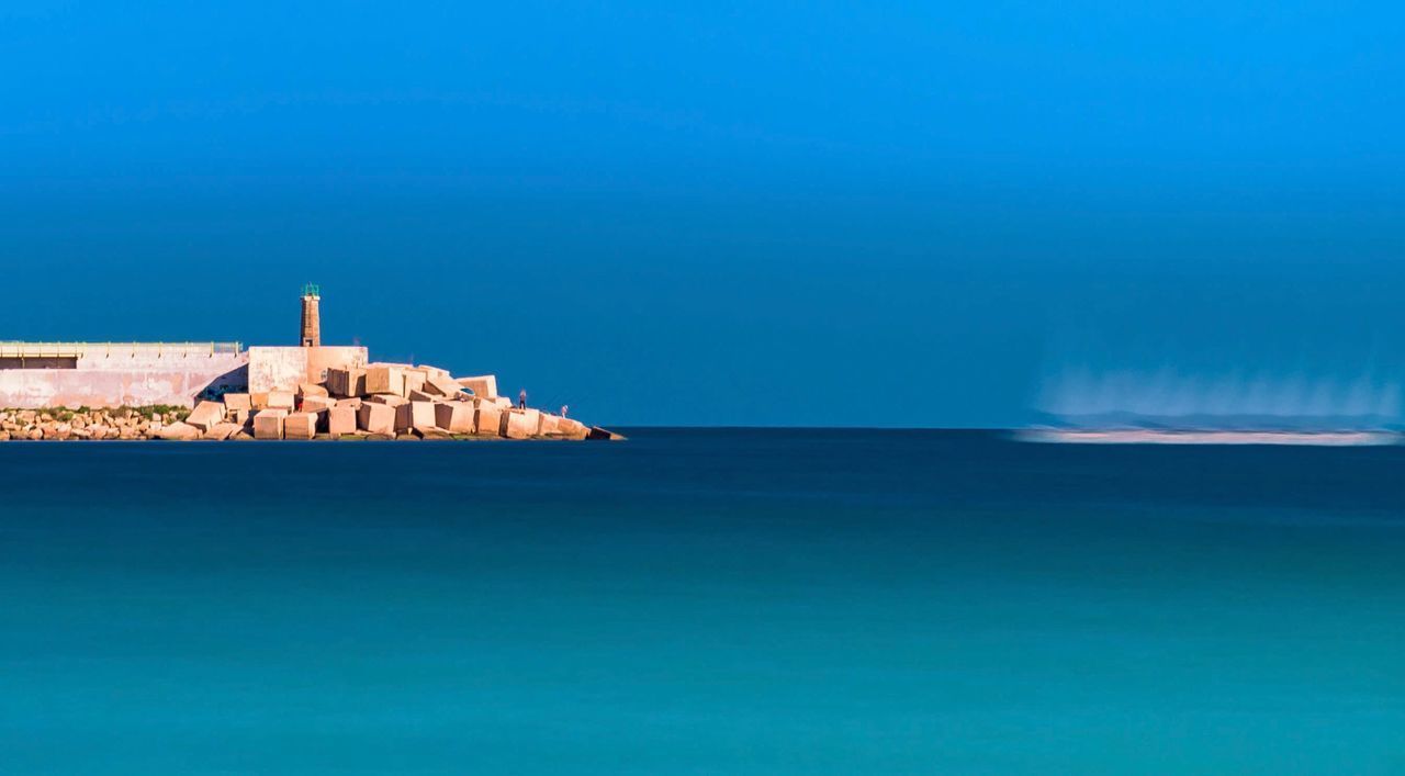 VIEW OF SEA AGAINST BUILDINGS