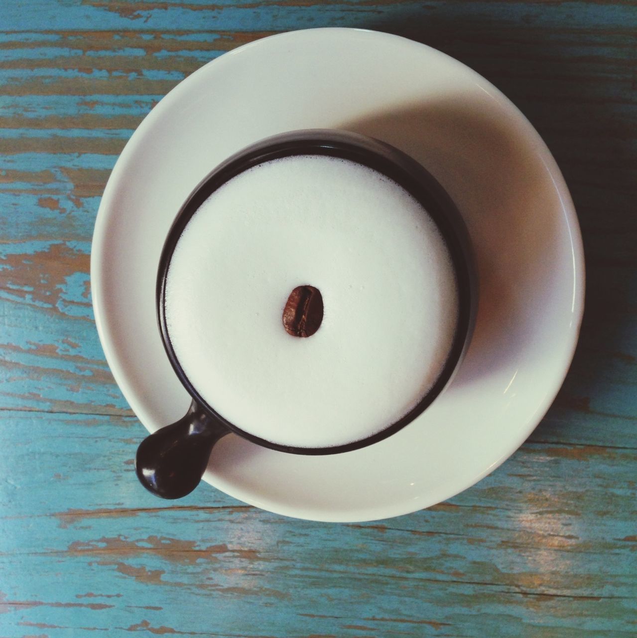 food and drink, indoors, table, coffee cup, still life, freshness, drink, refreshment, saucer, plate, spoon, coffee - drink, high angle view, food, cup, directly above, coffee, breakfast, close-up, healthy eating