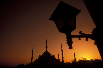 Low angle view of silhouette building against sky during sunset