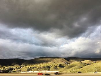 Scenic view of field against cloudy sky