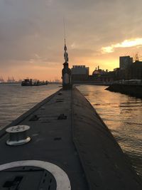 View of buildings at waterfront during sunset