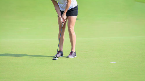 Low section of woman playing golf