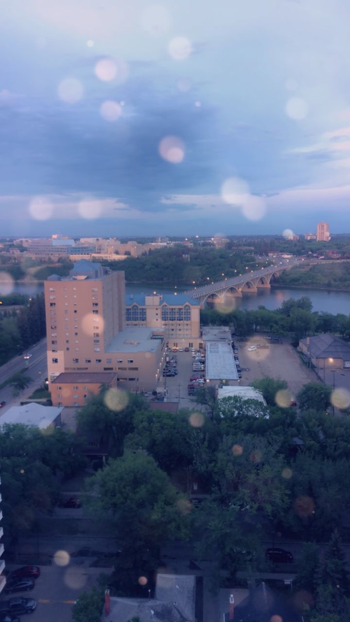 HIGH ANGLE VIEW OF ILLUMINATED BUILDINGS IN CITY