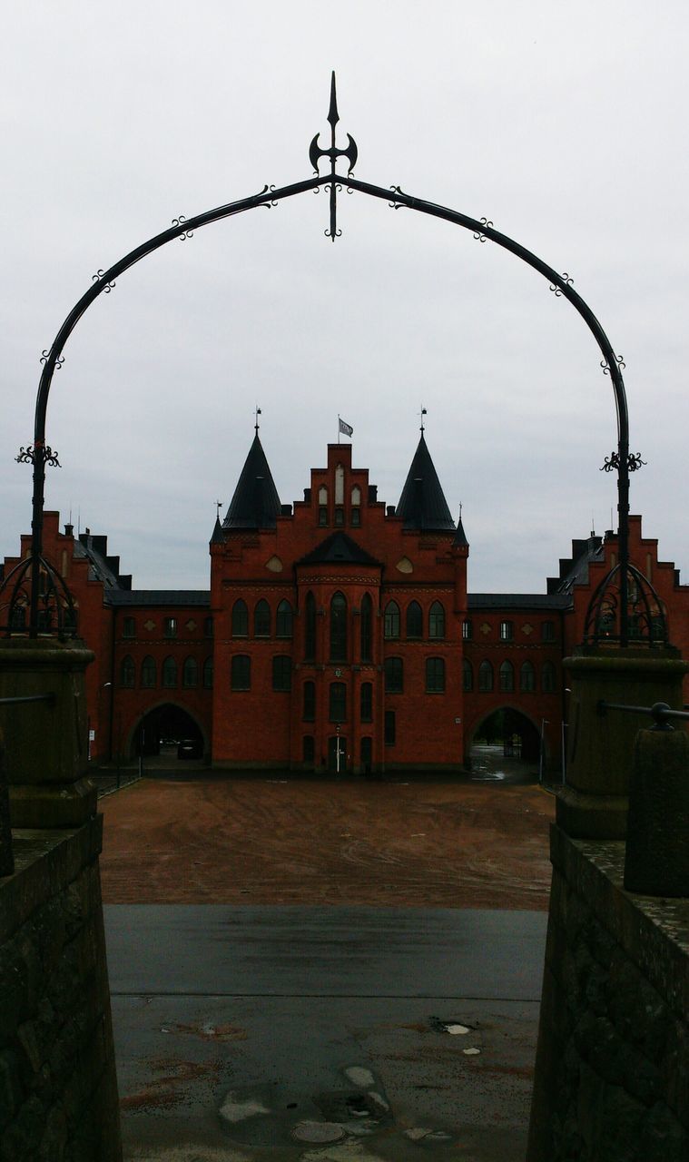 architecture, built structure, building exterior, sky, street light, lighting equipment, arch, railing, transportation, outdoors, city, street, no people, clear sky, incidental people, travel destinations, day, connection, gate, dusk