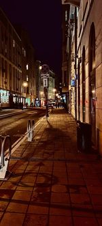 City street amidst buildings at night