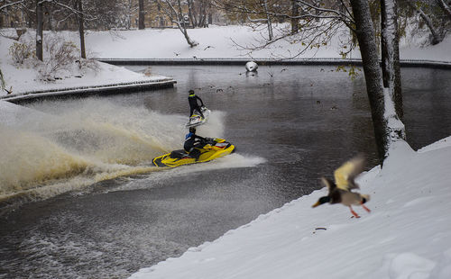 High angle view of people on jet skis on river during winter