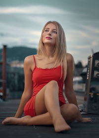 Portrait of young woman sitting on terrace