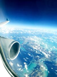 Aerial view of airplane wing over landscape