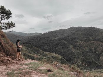 Man standing on mountain against sky