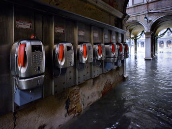 Pay phones on wall by water filled walkway during flood at st marks square