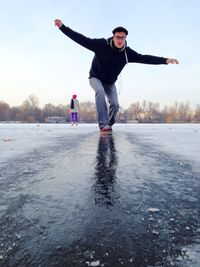 Full length of young man walking on frozen lake