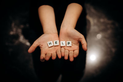 Close-up of human hand against black background